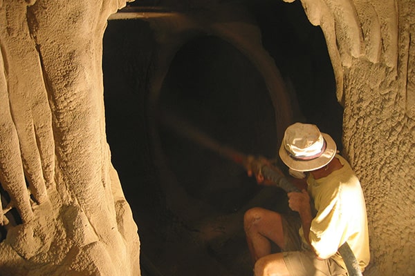 Man spraying concrete in caves of the City Museum
